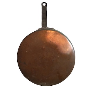 May include: A copper frying pan with a black metal handle. The pan has a worn, aged look.