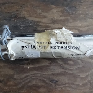 May include: Chrome exhaust extension for a motorcycle, packaged in a white paper bag with the text "Horvell Products Exhaust Extension" printed on it. A modern attractive accessory.