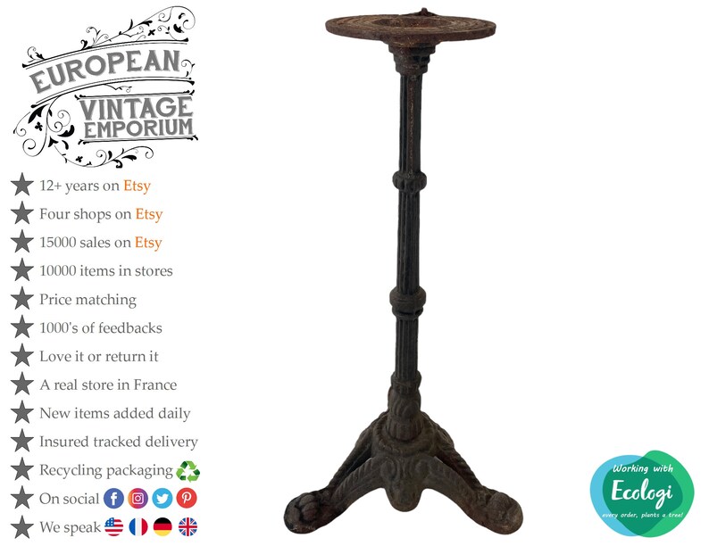 May include: A rustic, black cast iron bistro table stand with a round top and three legs. The stand has a decorative design on the legs and top.