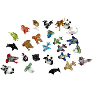 May include: A collection of 25 colourful glass animal figurines, including a panda, a rooster, a frog, a dolphin, a fish, a bird, a mouse, and a seahorse. The figurines are all hand-blown and have intricate details.