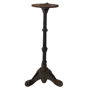 May include: A black cast iron table base with a round top and three legs. The base has a distressed finish.