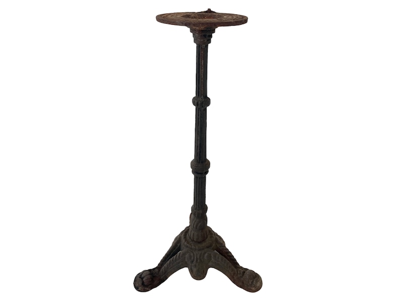 May include: A black cast iron table base with a round top and three legs. The base has a distressed finish.