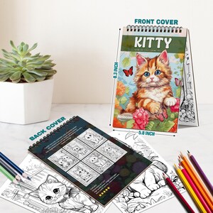 May include: A spiral-bound coloring book titled "KITTY" featuring a detailed illustration of a fluffy orange and white kitten with blue eyes. The front cover is 5.8 inches wide and 8.3 inches tall. The back cover shows multiple kitten drawings. Colored pencils are visible.