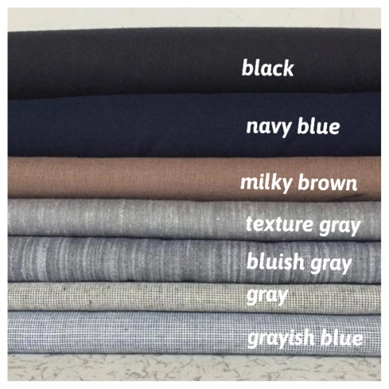 May include: A stack of fabric swatches in various shades of gray, blue, and brown. The swatches are labeled with the following colors: black, navy blue, milky brown, texture gray, bluish gray, gray, and grayish blue.