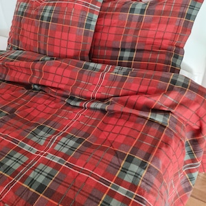 May include: Red, black, and yellow plaid bedding set with two matching pillowcases. The bedding is made of a soft, comfortable fabric and features a classic plaid pattern.