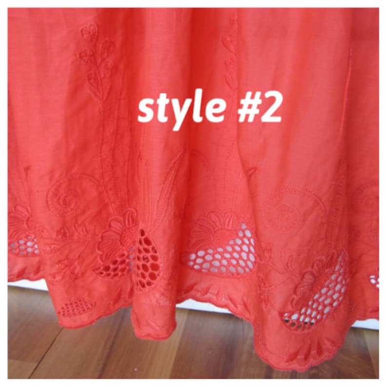 May include: Close-up of the bottom edge of a red cotton skirt with embroidered floral designs and cut-out details. The text "style #2" is visible in the center of the image.