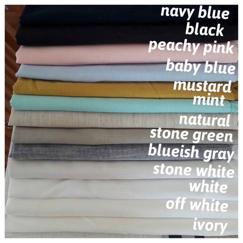 May include: A stack of 14 fabric swatches in various colors, including navy blue, black, peachy pink, baby blue, mustard, mint, natural, stone green, bluish gray, stone white, white, off white, and ivory.