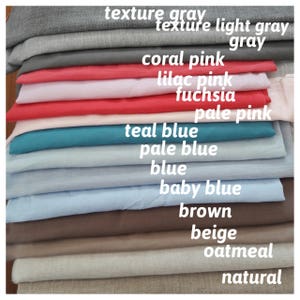 May include: A stack of fabric swatches in various colors, including natural, oatmeal, beige, brown, baby blue, blue, pale blue, teal blue, pale pink, fuchsia, lilac pink, coral pink, gray, light gray, and texture gray.