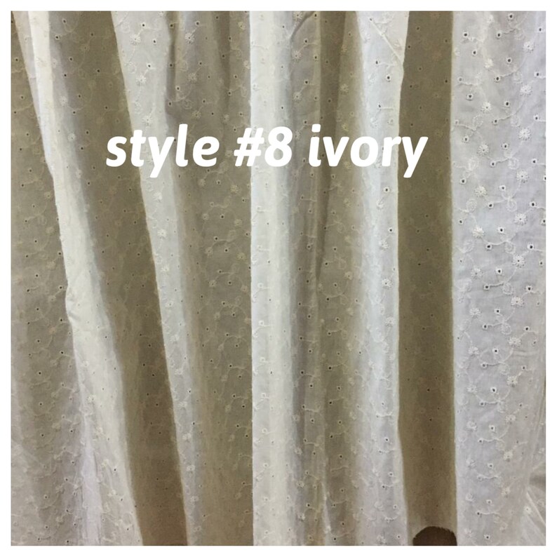 May include: Ivory white sheer curtain fabric with a small embroidered dot pattern. The fabric is labeled "style #8 ivory".