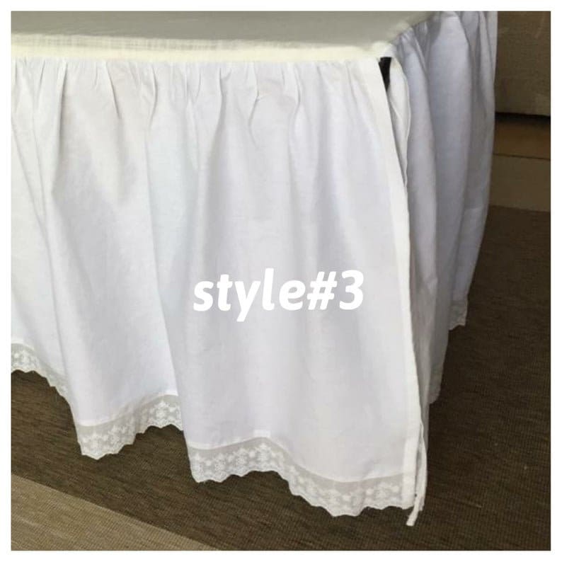 May include: White bed skirt with a lace trim. The skirt is gathered and has a tie at the side. The text "style#3" is printed on the skirt.