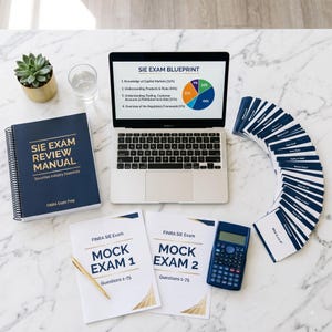 May include: A study set for the SIE exam including a spiral-bound review manual, two mock exam booklets, a laptop displaying an exam blueprint pie chart, a calculator, a gold pen, and a fan of flashcards with text on a white marble surface.