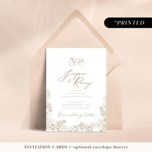 Minimal gold wedding invitations with tropical flowers, typographic printed invites, invitation cards