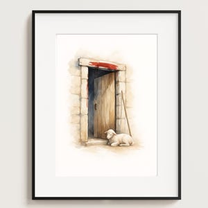 May include: Watercolor print of a lamb resting near a wooden door. The door is slightly ajar, revealing a glimpse of the interior. The artwork features a stone wall and a red accent above the door, all within a black frame.