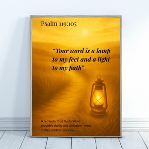 May include: Framed artwork with a golden landscape scene. The image features a path leading to a glowing lantern, with text from Psalm 119:105. The artwork is a reminder of God's Word providing clarity and direction.