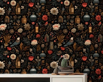 May include: Dark wallpaper featuring a repeating pattern of flowers, birds, and apothecary bottles in shades of brown, red, and cream. The wallpaper covers the wall behind a white cabinet with books and drawers.