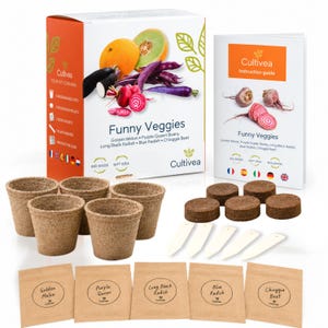 May include: A Cultivea Funny Veggies gardening kit featuring a white box with vegetable illustrations, five brown biodegradable pots, five compressed soil pellets, five white plant markers, and five brown seed packets labelled Golden Melon, Purple Queen, Long Black Radish, Blue Radish, and Chioggia Beet, plus an instruction guide.
