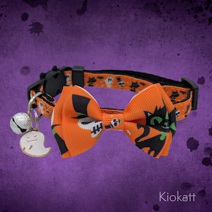 May include: Halloween-themed cat collar with an orange and black bow tie featuring a black cat and ghost design. The collar has a matching pattern of skulls and ghosts. Includes a silver bell and a white ghost charm.