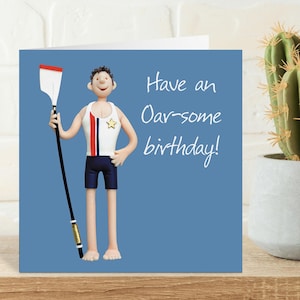 May include: Birthday card featuring a cartoon rower with an oar. The rower is dressed in a white vest with red and blue stripes, navy shorts, and a gold star. The card reads "Have an Oar-some birthday!" on a blue background.