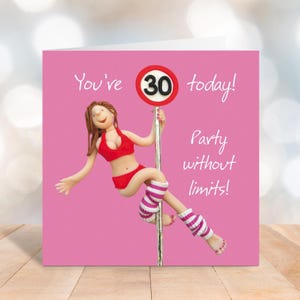 May include: A birthday card with a pink background features a figurine in a red outfit holding a sign that says "30". The card reads "You're 30 today! Party without limits!"
