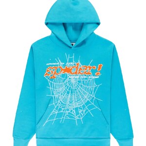 May include: A turquoise hoodie with a hood and a front pocket. The front features a white spiderweb design with the word "Spider!" in orange, and additional text above and below the word.