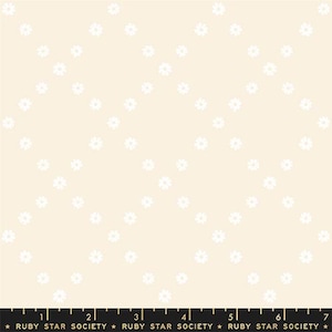 May include: Cream-colored fabric with a repeating pattern of small white daisy-like flowers arranged in diagonal rows. The fabric has a soft, delicate appearance, suitable for quilting or apparel.