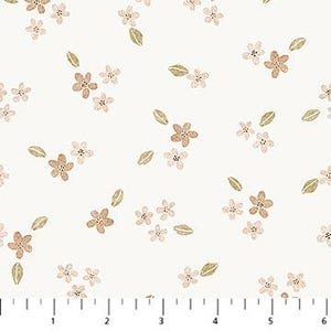 May include: A white fabric featuring a repeating pattern of small, light brown five-petaled flowers and olive green leaves, positioned above a ruler showing six inches to provide a clear scale for the floral print design.