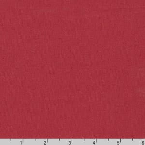 May include: A close-up of a solid red fabric with a textured weave. The fabric appears to be a medium weight material, suitable for various sewing projects. The image is well-lit, showing the color and texture clearly.