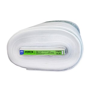 May include: A roll of white fabric, labeled "TP971 Fusible Thermolam Plus." The fabric is tightly wound, showing a textured surface. The label is green and white, with product information and a barcode. The fabric is likely used for crafting or sewing projects.