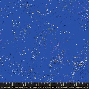 May include: Blue fabric with a speckled pattern in shades of gold, purple, and gray. The fabric has a dark blue background and a repeating pattern of small, irregular dots. The text "RUBY STAR SOCIETY" is at the bottom.