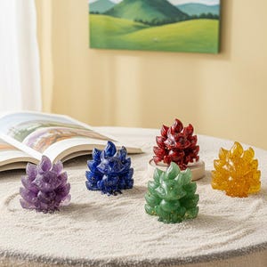 May include: A collection of colorful crystal fox figurines. The foxes are in shades of purple, blue, red, green, and yellow. Each fox has a detailed, textured design. The figurines are displayed on a light-colored surface.