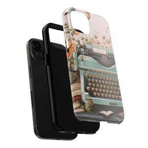 May include: A phone case with a vintage typewriter design. The typewriter is blue and green with a white background. The case is surrounded by floral designs and a book.