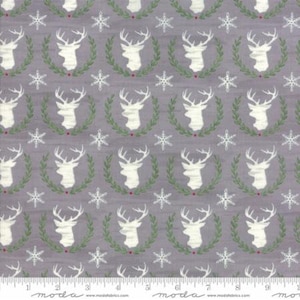 May include: A gray fabric with a repeating pattern of white deer heads inside green wreaths and white snowflakes. The fabric has a subtle texture.