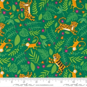 May include: A green fabric with a repeating pattern of orange monkeys, tigers, and leopards. The animals are surrounded by green leaves and pink flowers. The fabric has a ruler with the words "moda" printed on it.
