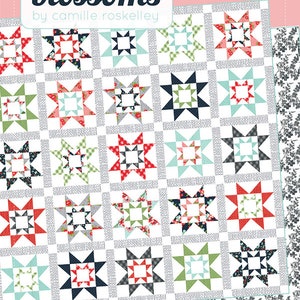 May include: A quilting pattern called "Grace" by Thimble Blossoms, a fat quarter friendly quilt with a white background and a repeating pattern of colorful stars.