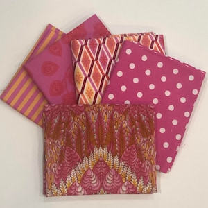 May include: Five fabric swatches in various pink and orange patterns. The swatches include a pink and orange geometric pattern, a pink and orange floral pattern, a pink and orange striped pattern, a pink polka dot pattern, and a pink and orange paisley pattern.