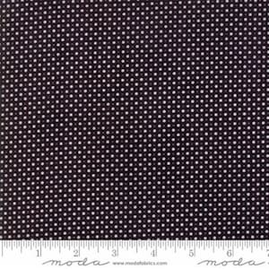 May include: Black fabric with a white polka dot pattern. The fabric is shown with a ruler that reads "moda" and "www.modafabrics.com".