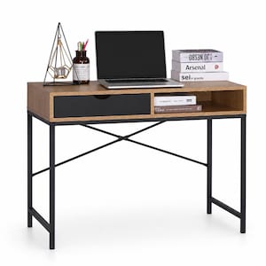 May include: A contemporary desk with a light brown wooden surface and a black drawer. The desk features a black metal frame and a laptop, books, and decorative items. Ideal for a home office or study space.