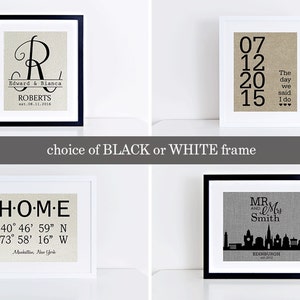 May include: Four framed prints with different designs on a white background. The prints are in black and white frames. The first print has a large letter R with the text "Edward & Bianca Roberts est. 08.31.2016". The second print has the text "07 12 20 15 The day we said I do". The third print has the text "HOME 40&deg; 46' 59" N 73&deg; 58' 16" W Manhattan, New York". The fourth print has the text "MR. & Mrs. Smith EDINBURGH est. 2012" and a silhouette of the Edinburgh skyline.