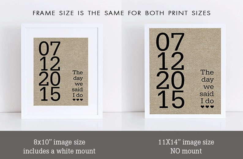 May include: Two white frames with black mounts, each displaying a beige linen print with black text. The text reads "07 12 20 15 The day we said I do" with three hearts. The smaller frame is 8x10 inches and includes a white mount. The larger frame is 11x14 inches and has no mount.