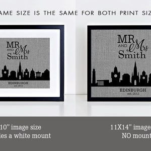 May include: Two black framed prints of a cityscape with the text "MR & Mrs Smith" and "EDINBURGH est. 2012". The print on the left is 8x10 inches and includes a white mount. The print on the right is 11x14 inches and has no mount.