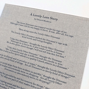 May include: A black and white printed page with the title "A Lovely Love Story" by Edward Monkton. The text describes a fierce dinosaur trapped in a cage of ice who is melted by the love of another dinosaur.