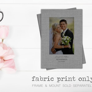 May include: A grey fabric print featuring a wedding photograph of a couple in front of a green background. The text "Jennifer & William HENDERSON 07.10.2017" is printed below the photo.