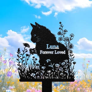May include: Black metal cat silhouette garden stake with the text "Luna Forever Loved." The cat is surrounded by a floral design with a blue sky and clouds in the background. The stake is designed to be placed in a garden.