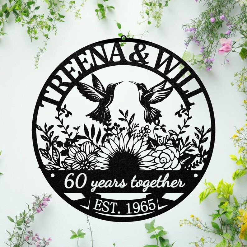 May include: Black metal wall art featuring the names "TREENA & WILL" and two hummingbirds facing each other. The design includes floral elements and the text "60 years together" and "EST. 1965" in a circular shape.
