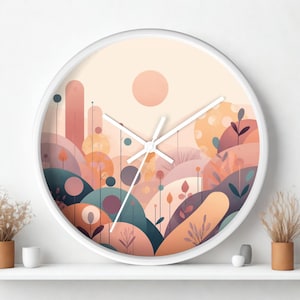 May include: A round wall clock with a white frame and white hands. The clock face features a stylized landscape illustration in shades of peach, coral, muted blue, and cream, depicting rolling hills, tall thin plants, and a large circular sun.