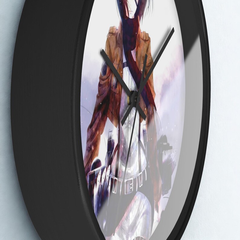 May include: Black round wall clock featuring an anime character in a brown jacket and white shirt. The clock has black hands and a black frame. The background is a blurred image of a building.