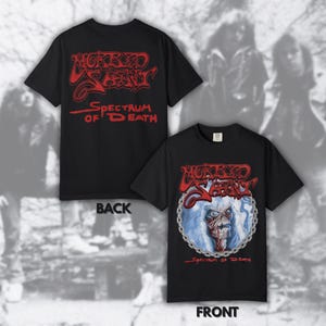 May include: Black t-shirt featuring the band name "Wicked Sceptre" in red, with "Spectrum of Death" below. The front design includes a skull illustration within a chain border. The back of the shirt also displays the band name and text.