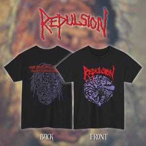 May include: Black t-shirts with the word "Repulsion" in red, stylized lettering. One shirt features a purple graphic of a face and the other has a purple illustration of a skull. The back of one shirt has the text "MIND THRUST OBSESS YOU LIVE A HELLISH DREAM".
