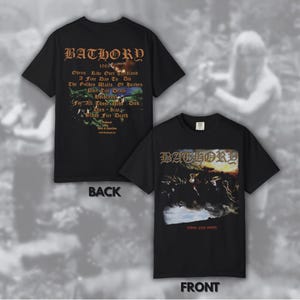 May include: Black t-shirts with the band name "BATHORY" in gothic font. One shirt shows the back with lyrics and the other the front with an image of a battle scene. The shirts are a music-themed apparel.