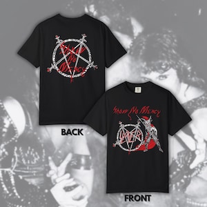 May include: A black short-sleeved t-shirt featuring a graphic print. The front displays a horned figure with a red cape, a pentagram, and the text Slayer and Show No Mercy. The back features a white pentagram design with the text Show No Mercy.